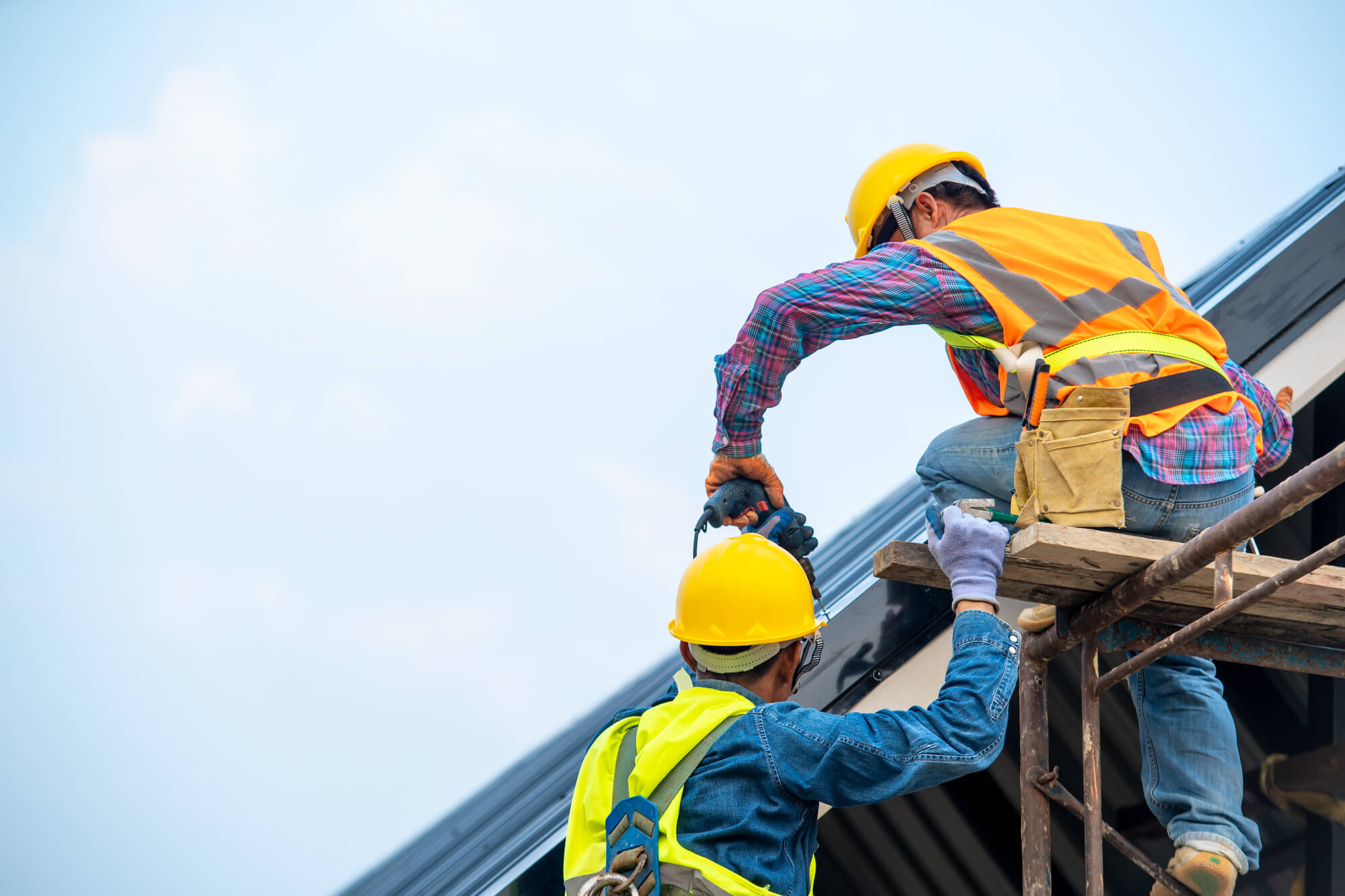 men from a commercial roofing company in texas fixing a roof