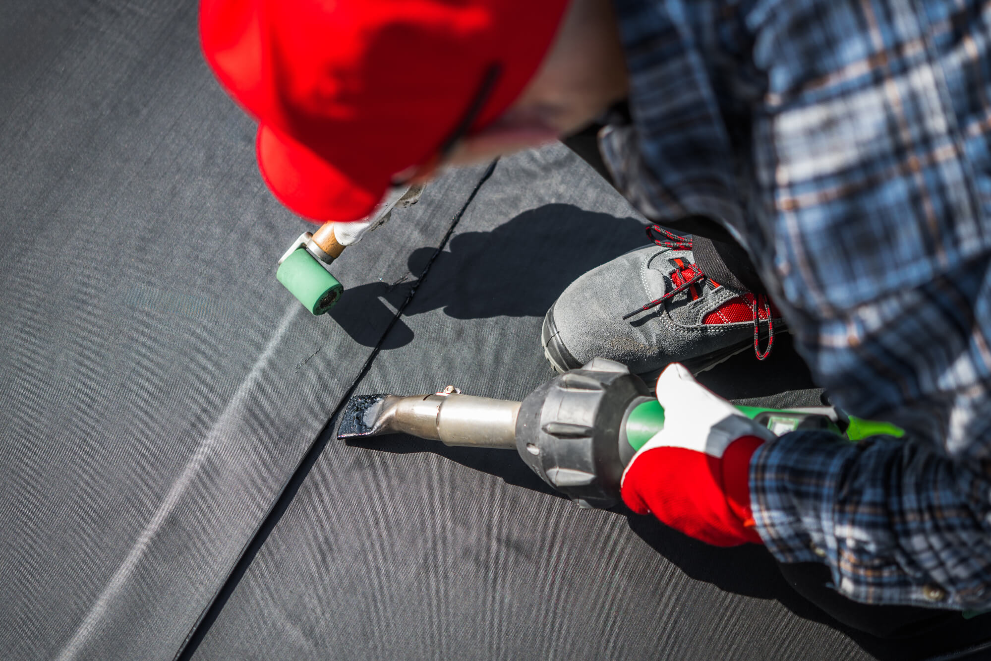 professional replacing commercial metal roofing with EPDM roofing