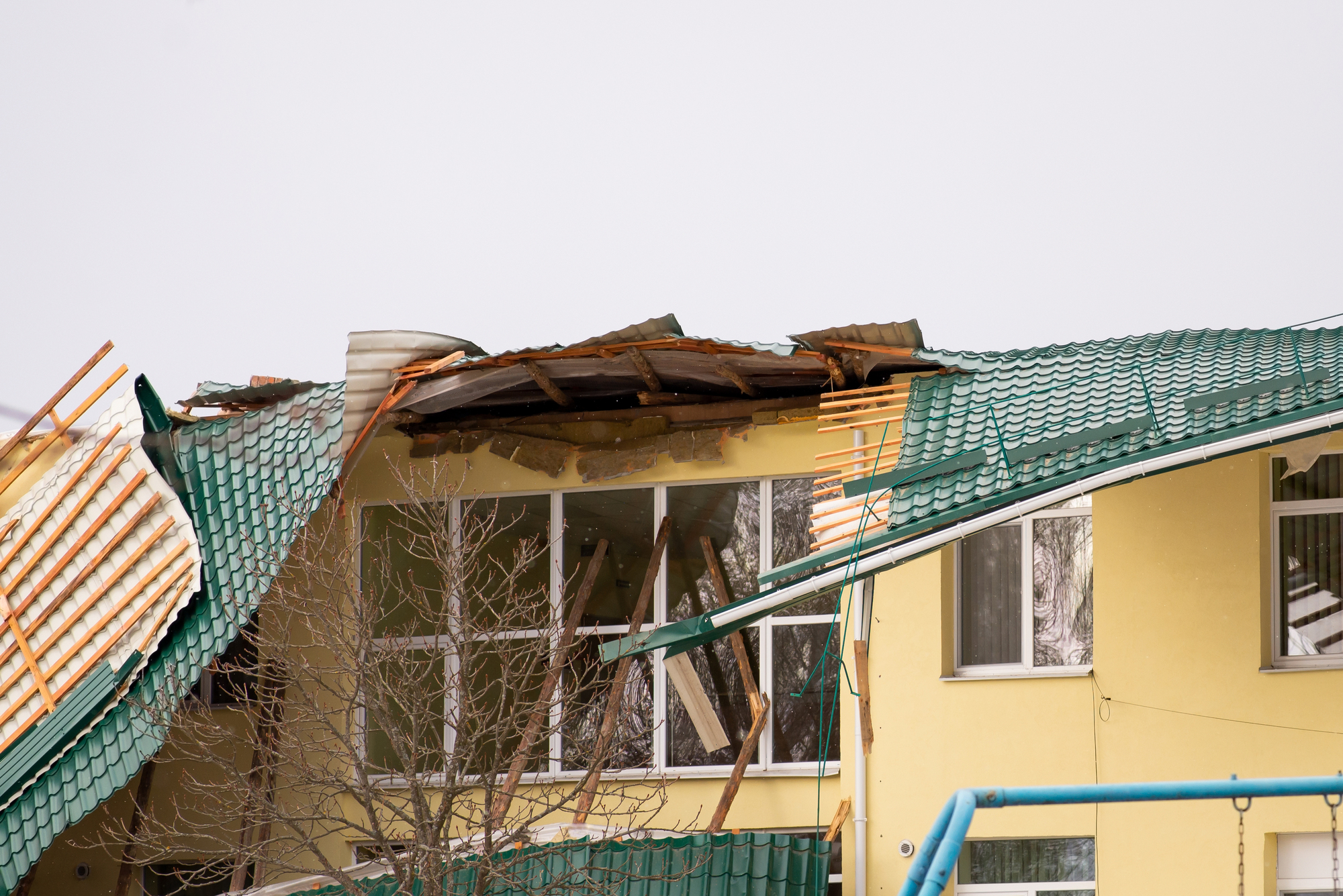 commercial building roof in need of storm damage restoration