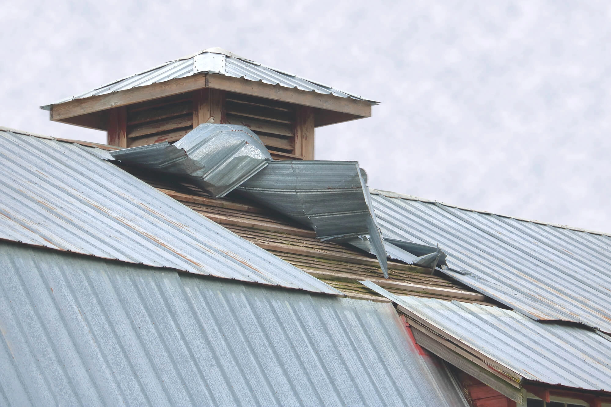damaged commercial metal roofing