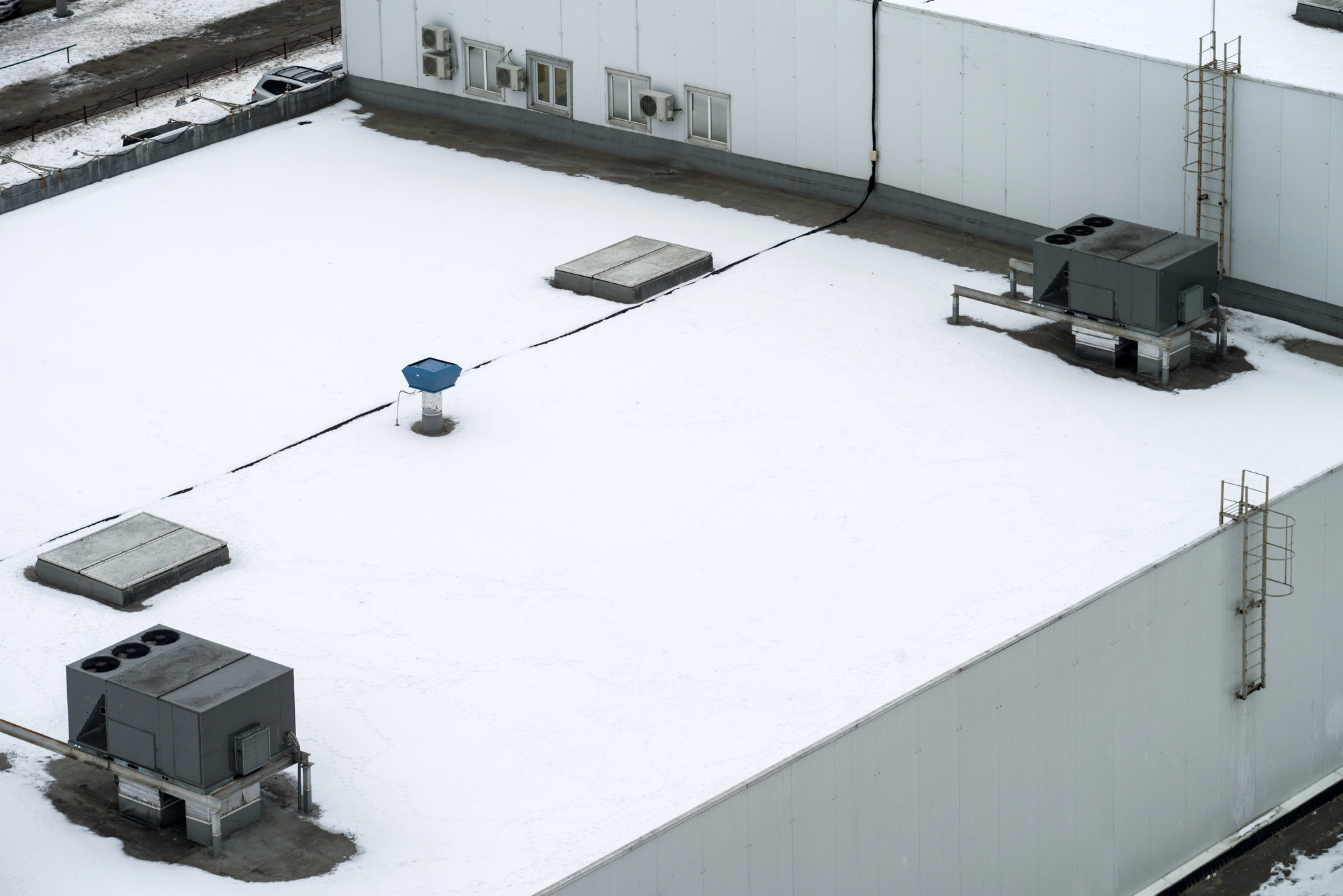 commercial roofing system covered in snow