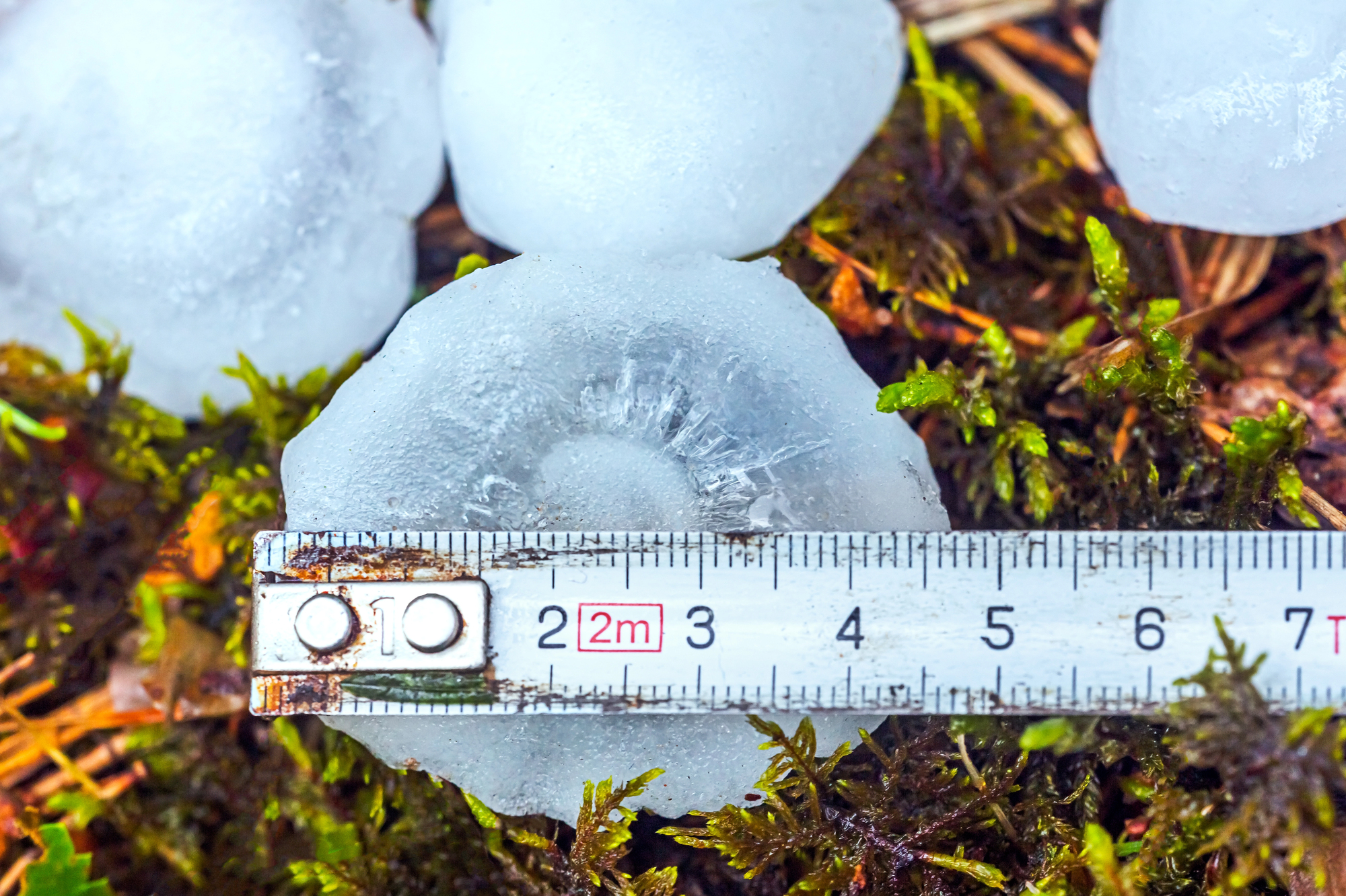 measuring hail that causes damage to commercial roofing