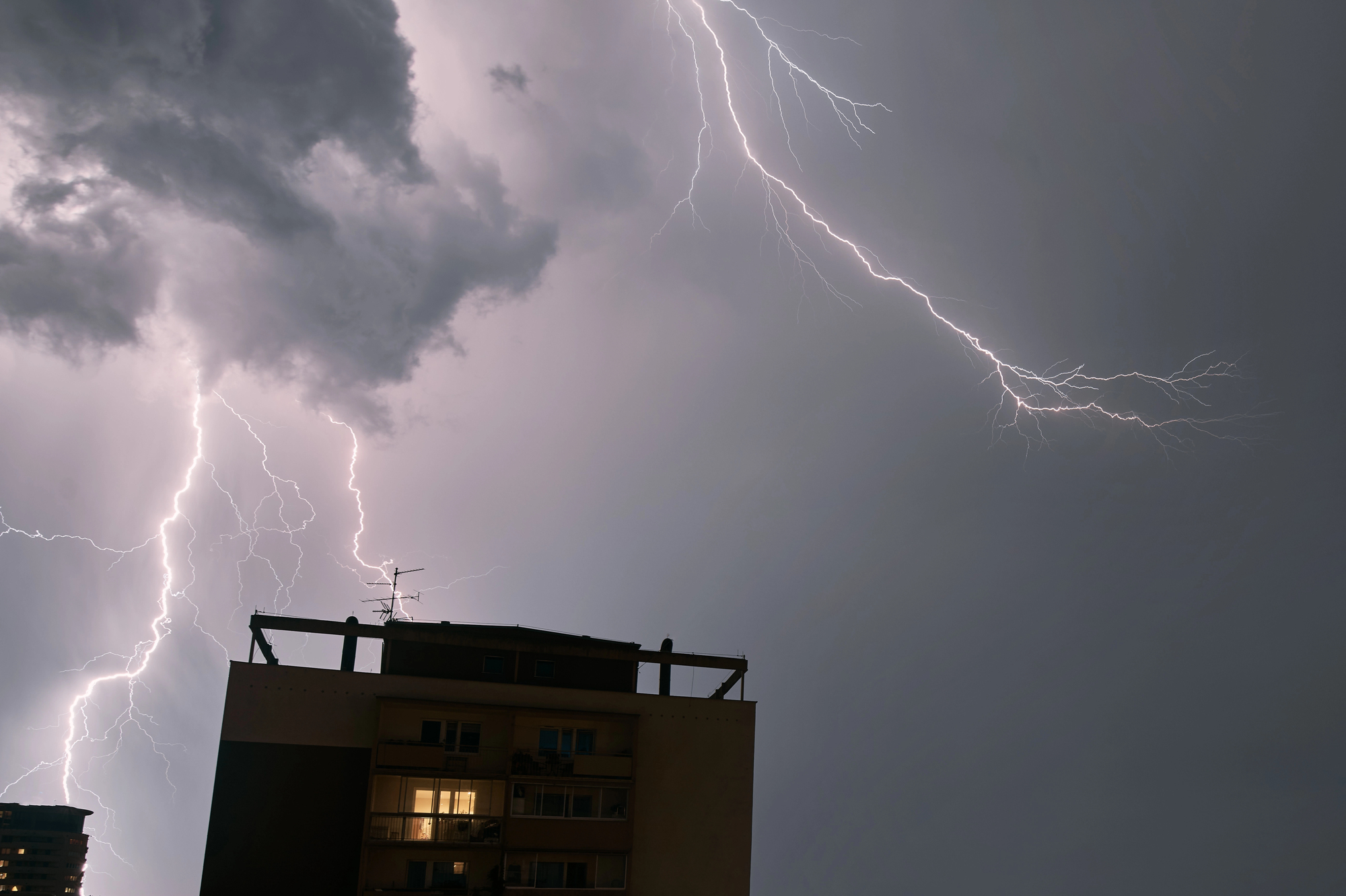 thunderstorm over building that needs storm damage repair